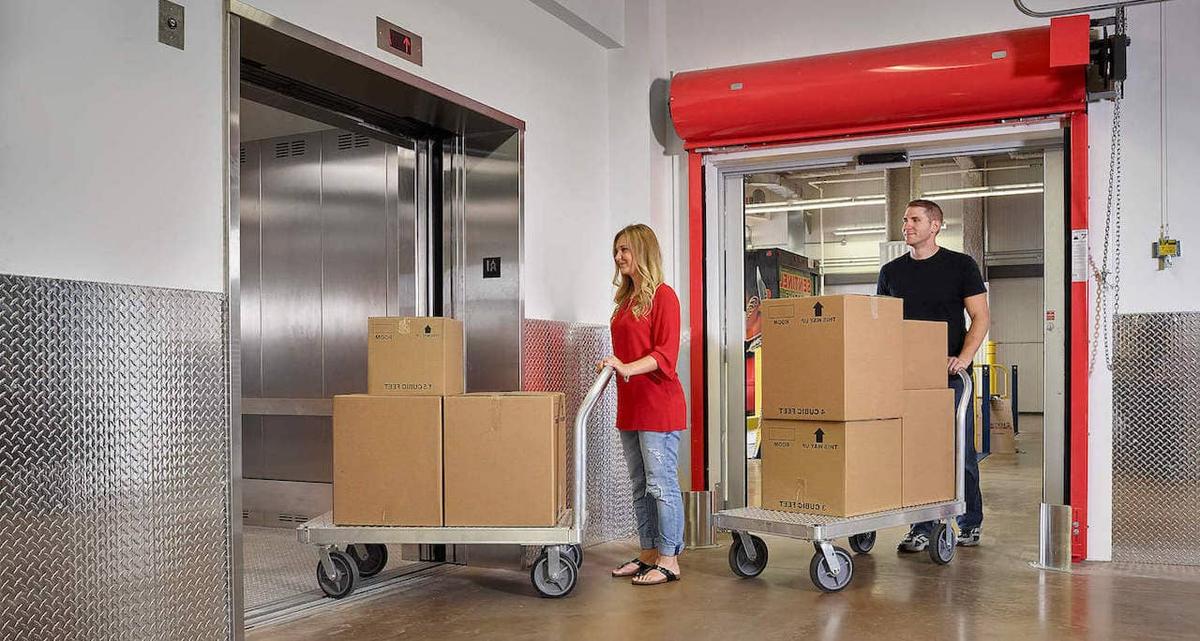 couple Loading an elevator self storage